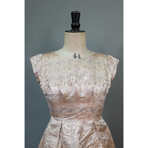 938 - A 1950s pink and gold Chinese brocade evening gown by Caley's of Windsor; a cream and gold gauze dre... 