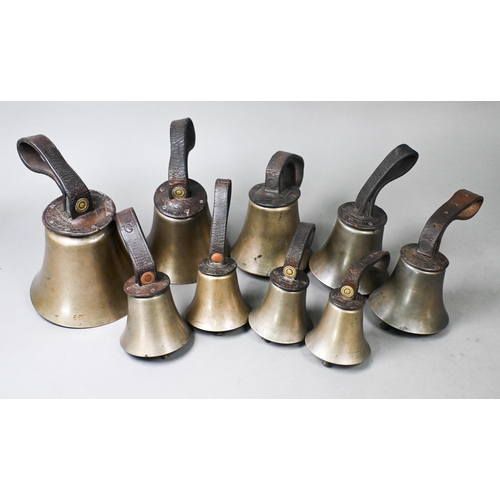 969 - A graduated matched set of nine hand-bells with leather wrist straps, some stamped for Mears and Sha... 