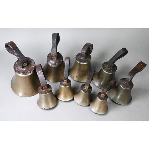 969 - A graduated matched set of nine hand-bells with leather wrist straps, some stamped for Mears and Sha... 