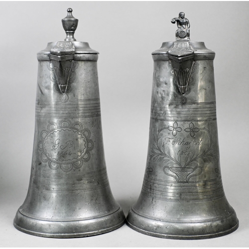 972 - Two 19th century German pewter flagons with wrigglework decoration, dated 1858/64, 29 cm high c/w a ... 