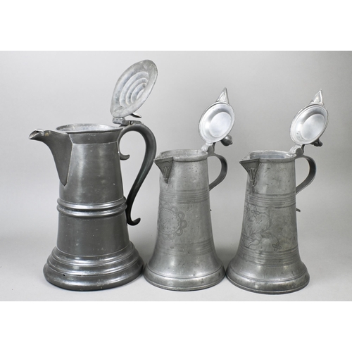 972 - Two 19th century German pewter flagons with wrigglework decoration, dated 1858/64, 29 cm high c/w a ... 