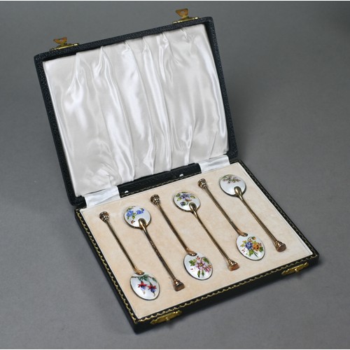 103 - A cased set of six silver gilt coffee spoons with floral enamelled bowls and seal finials, William S... 