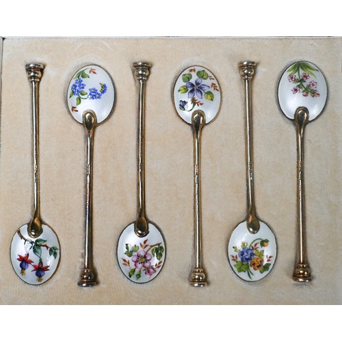 103 - A cased set of six silver gilt coffee spoons with floral enamelled bowls and seal finials, William S... 