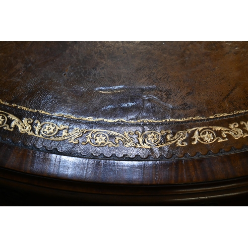 675 - A Victorian mahogany library drum table, the gilt tooled tan leather inset revolving top with four a... 