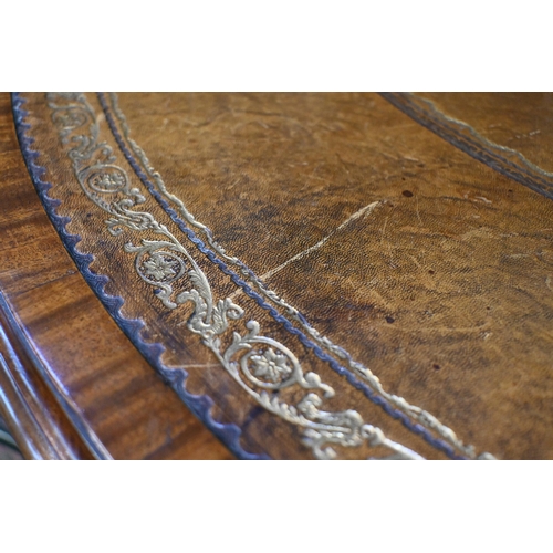 675 - A Victorian mahogany library drum table, the gilt tooled tan leather inset revolving top with four a... 