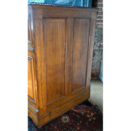 707 - An antique American Wells Fargo 'Wooton' style desk, golden oak, the hinged upper panel over a pair ... 