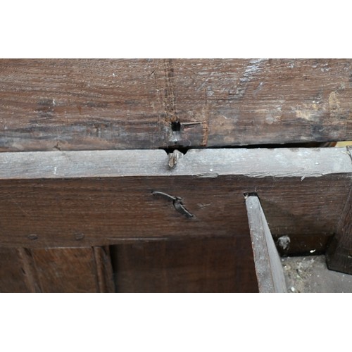 734 - An early 18th century oak coffer, the wide two plank staple hinged top over an ornate relief carved ... 
