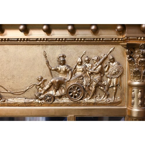 656 - A Victorian style giltwood framed landscape over mantel mirror, the deep frieze with applied lion an... 