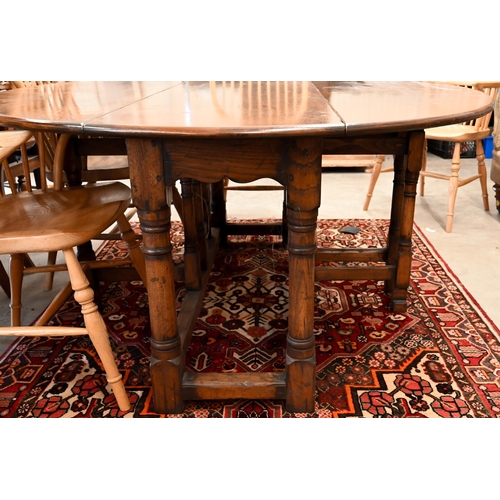 7 - A contemporary oak drop leaf 'wake' dining table, the oval top raised on a gateleg frame, 169 x 48 (... 