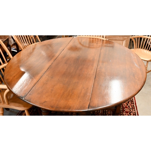 7 - A contemporary oak drop leaf 'wake' dining table, the oval top raised on a gateleg frame, 169 x 48 (... 