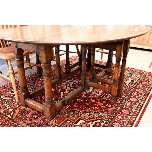 7 - A contemporary oak drop leaf 'wake' dining table, the oval top raised on a gateleg frame, 169 x 48 (... 