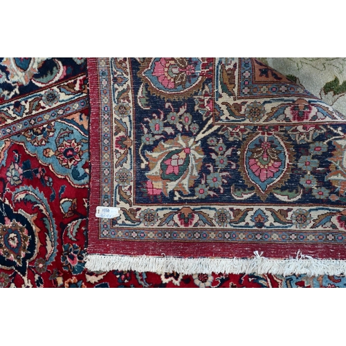 81 - A contemporary Persian Kashan carpet, the blue ground with multi-coloured geometric design, 384 cm x... 