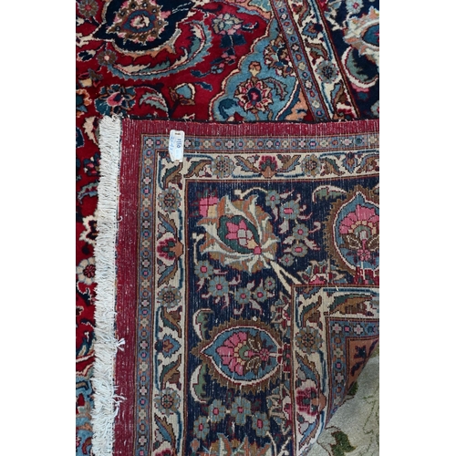 81 - A contemporary Persian Kashan carpet, the blue ground with multi-coloured geometric design, 384 cm x... 