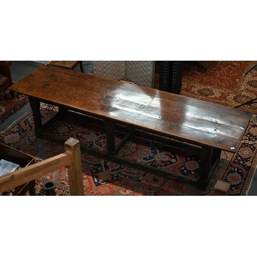 A 17th century oak refectory table, the four plank top raised on a joined six moulded and chamfered legs united by square peripheral stretchers, 300 cm long x 83.5 cm x 75.5 cm h, faults, alterations, losses, etc