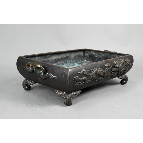 522 - An early 20th century Japanese bronze two-handled jardinière or hibachi, cast in high relief with a ... 