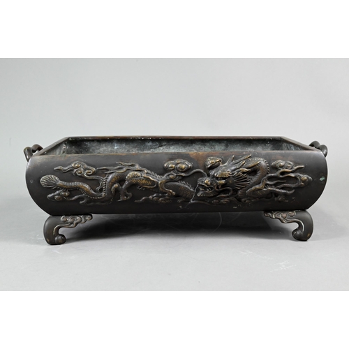 522 - An early 20th century Japanese bronze two-handled jardinière or hibachi, cast in high relief with a ... 