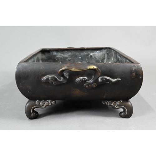 522 - An early 20th century Japanese bronze two-handled jardinière or hibachi, cast in high relief with a ... 