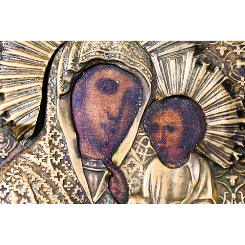 494 - An antique Coptic icon of Mary and Jesus, with painted features in embossed brass surround, 17 x 14 ... 