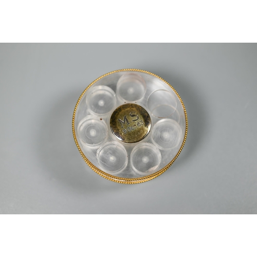 460 - Asprey - a round lucite sliding pill box with six recesses, vermeil edging and silver gilt centres, ... 