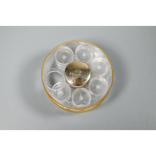 460 - Asprey - a round lucite sliding pill box with six recesses, vermeil edging and silver gilt centres, ... 