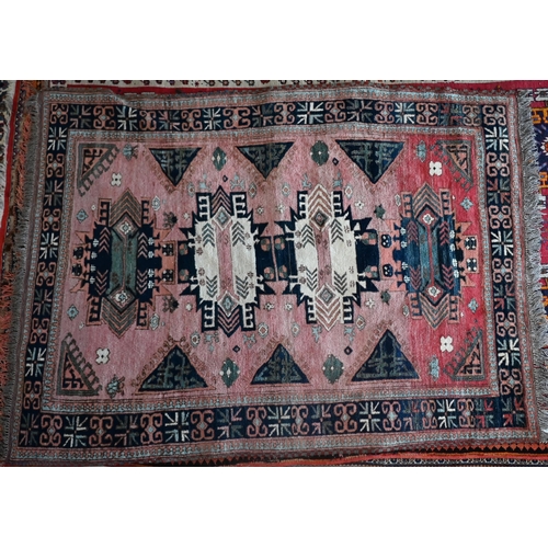 186 - A mid-century Turkish rug, the faded red ground rug with geometric design, 228 cm x 164 cm