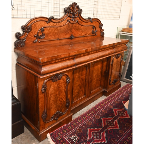 150 - A Victorian mahogany sideboard with scrolling raised back above three pulvinated frieze drawers on i... 