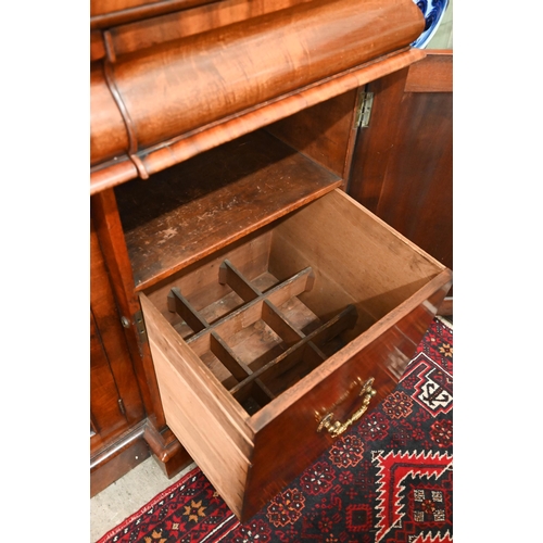 150 - A Victorian mahogany sideboard with scrolling raised back above three pulvinated frieze drawers on i... 