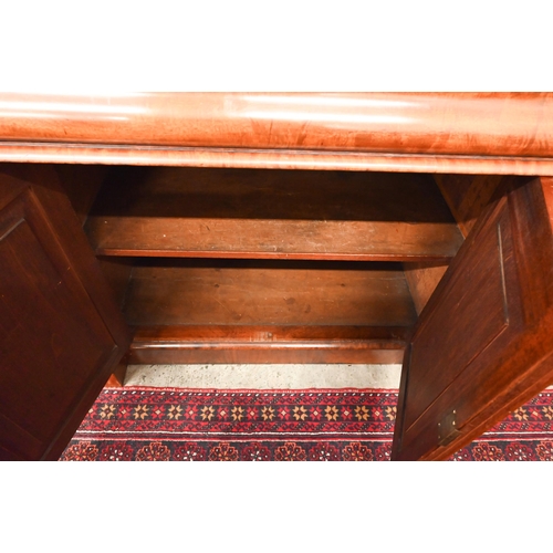 150 - A Victorian mahogany sideboard with scrolling raised back above three pulvinated frieze drawers on i... 