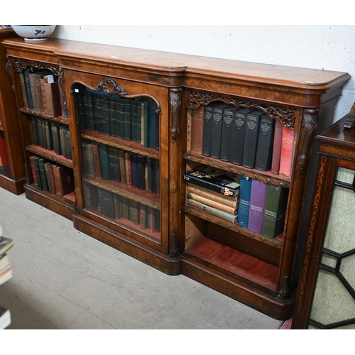 1 - A Victorian walnut breakfront bookcase with fret-cut and carved decorative mouldings, glazed central... 