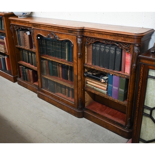 1 - A Victorian walnut breakfront bookcase with fret-cut and carved decorative mouldings, glazed central... 