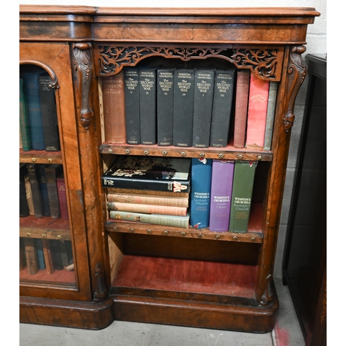 1 - A Victorian walnut breakfront bookcase with fret-cut and carved decorative mouldings, glazed central... 