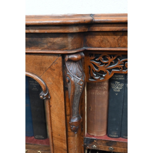 1 - A Victorian walnut breakfront bookcase with fret-cut and carved decorative mouldings, glazed central... 