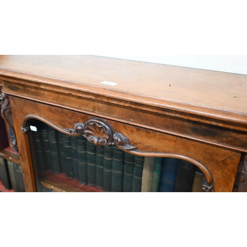 1 - A Victorian walnut breakfront bookcase with fret-cut and carved decorative mouldings, glazed central... 