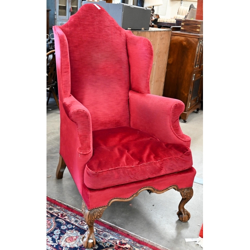 101 - A walnut framed Queen Anne style wingback armchair, acanthus carved cabriole front legs with ball an... 