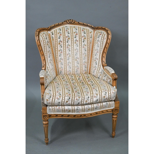 106 - A French wingback armchair, 20th century, floral brocade-style striped fabric