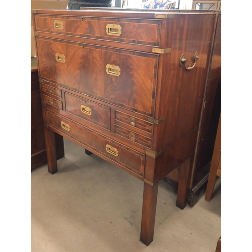 113 - A reproduction mahogany brass mounted secretaire chest on stand with arrangement of drawers surround... 