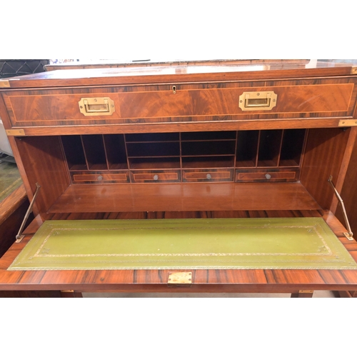 113 - A reproduction mahogany brass mounted secretaire chest on stand with arrangement of drawers surround... 