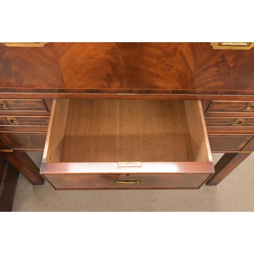 113 - A reproduction mahogany brass mounted secretaire chest on stand with arrangement of drawers surround... 