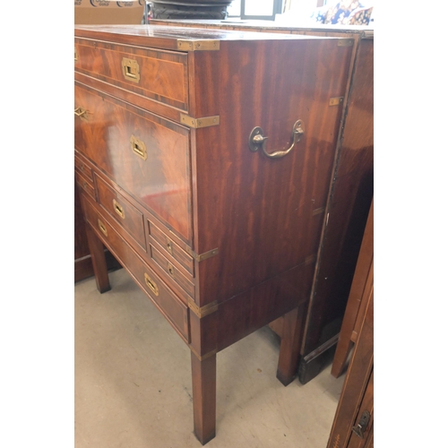 113 - A reproduction mahogany brass mounted secretaire chest on stand with arrangement of drawers surround... 