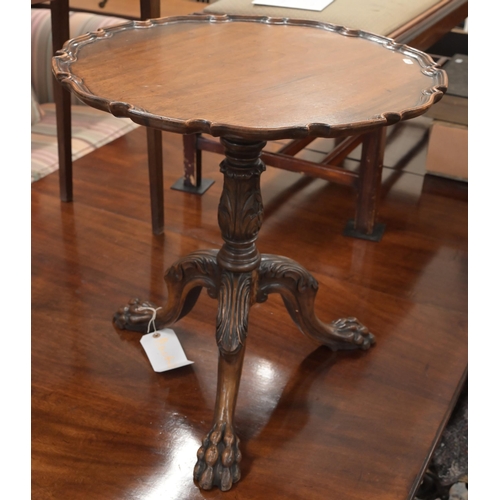 116 - A mahogany occasional table with scalloped tilt-top on carved tripod base with paw feet, 56 cm diam ... 