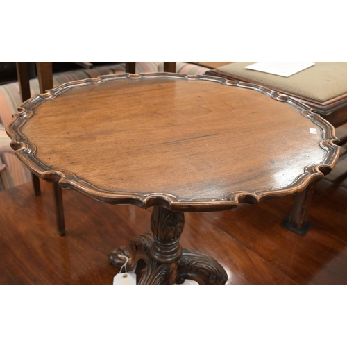 116 - A mahogany occasional table with scalloped tilt-top on carved tripod base with paw feet, 56 cm diam ... 