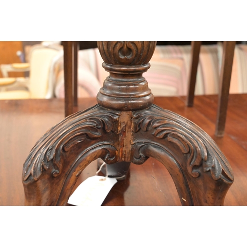 116 - A mahogany occasional table with scalloped tilt-top on carved tripod base with paw feet, 56 cm diam ... 