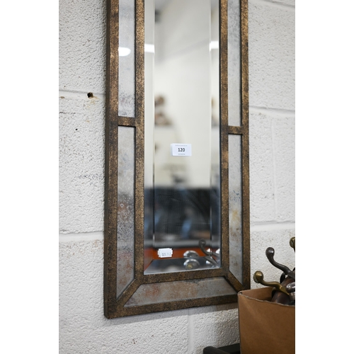 120 - A narrow bevelled wall mirror with antiqued glass borders and metal frame with anethmion crest, 28 x... 