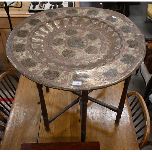 123 - # A vintage Indian Benares brass tray top table with engraved and enamelled Peacock design, on foldi... 