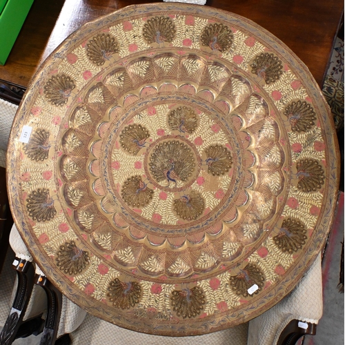 123 - # A vintage Indian Benares brass tray top table with engraved and enamelled Peacock design, on foldi... 