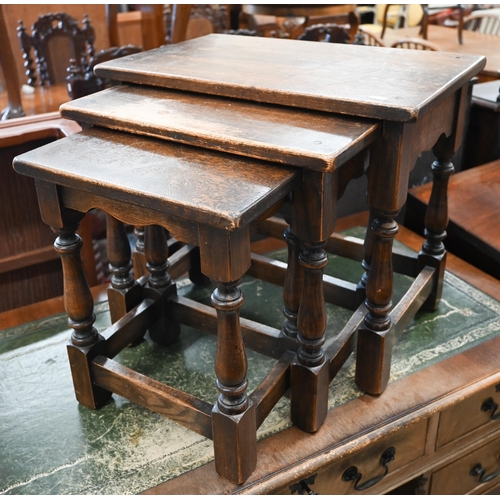 126 - A nest of three oak tables with turned supports and stretchers, the largest 54 x 34 x 48 cm high