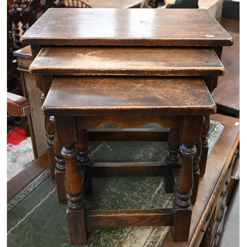 126 - A nest of three oak tables with turned supports and stretchers, the largest 54 x 34 x 48 cm high