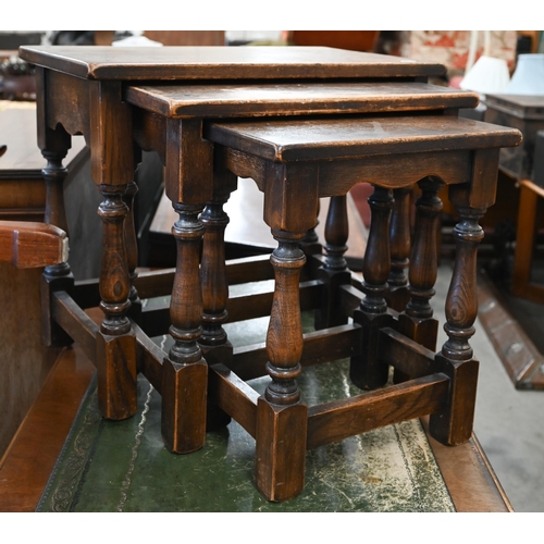 126 - A nest of three oak tables with turned supports and stretchers, the largest 54 x 34 x 48 cm high