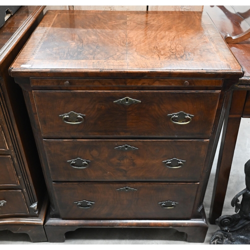 130 - A small antique walnut chest with cross and featherbanded top over brushing slide and three graduati... 