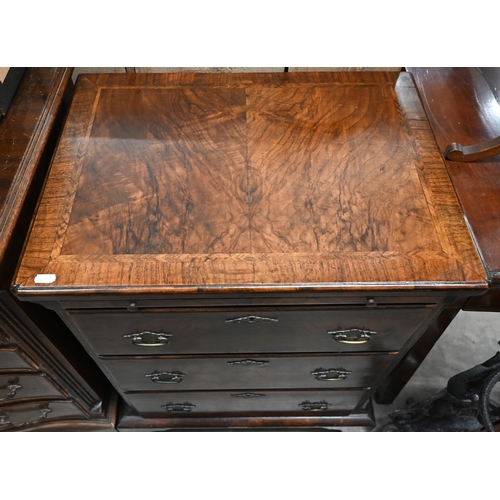 130 - A small antique walnut chest with cross and featherbanded top over brushing slide and three graduati... 